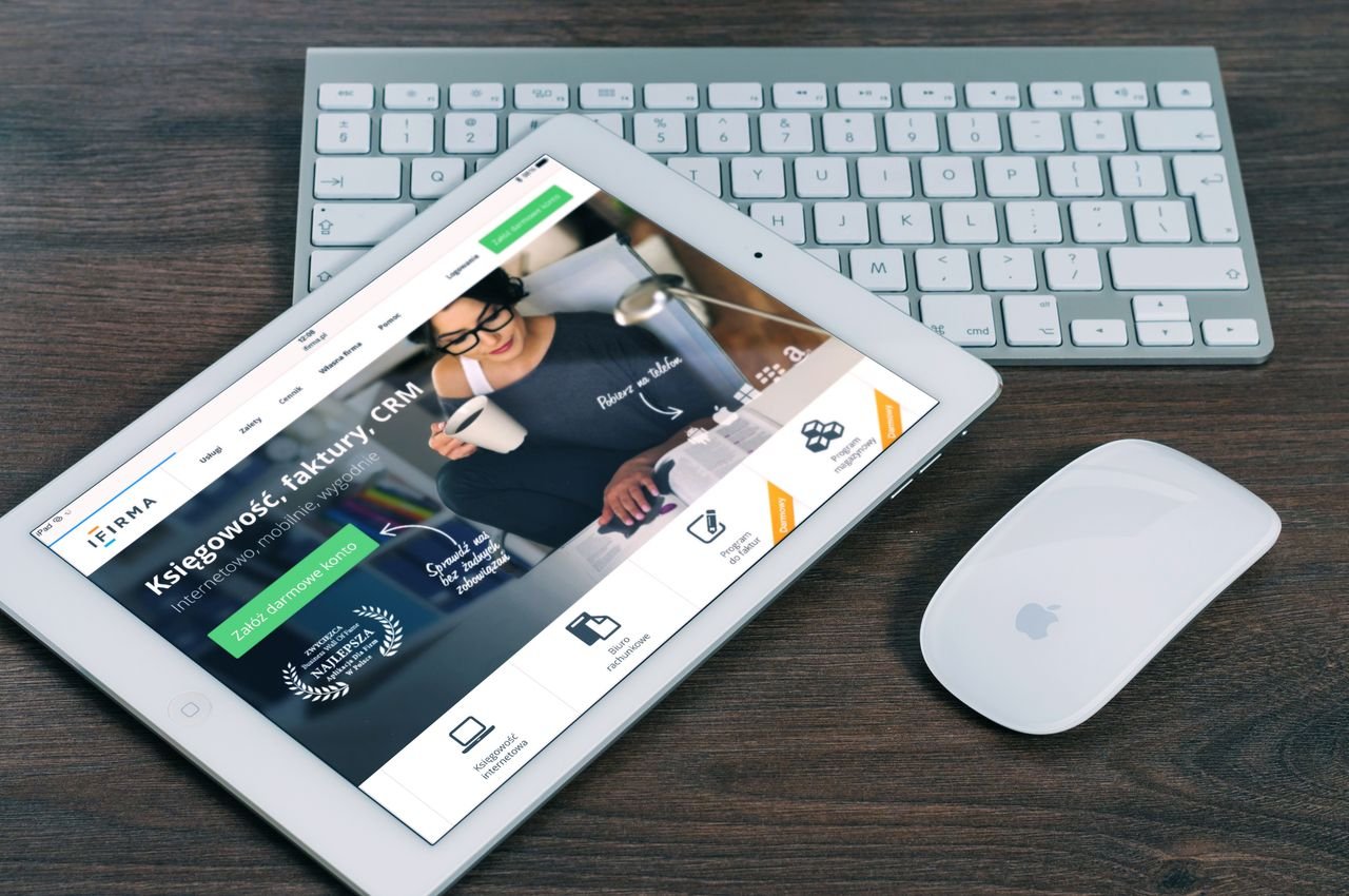 about-us A tablet with a financial website open, alongside a white keyboard and mouse. Ideal for tech-theme stock images.